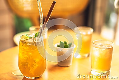 Clear wellness yellow drink lemonade, fruit ice kombucha, green chia seed tea with reusable glass straw in glassfull on Stock Photo