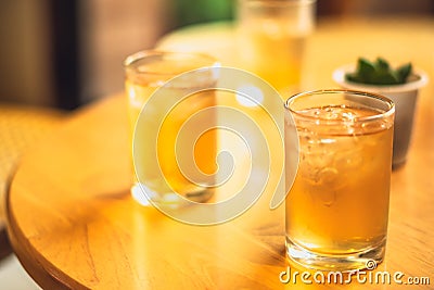 Clear wellness yellow drink lemonade, fruit tea, ice kombucha, green tea in two glasses on wooden table with small Stock Photo
