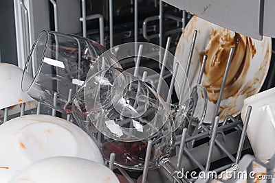 The clear wine glasses were put in the dishwasher for cleaning Stock Photo