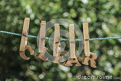 CLEAR word written by hanged wooden letters on rope at garden Stock Photo