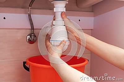 Clearing of blocked hammered polluted plastic U siphon for wash basin, sanitary devices, plumbing fixtures special means cleanser Stock Photo