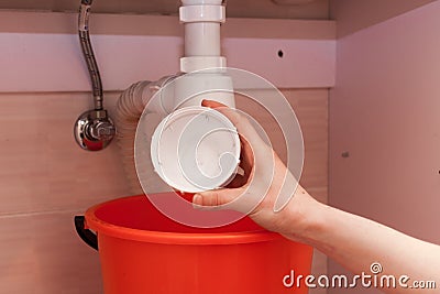 Clearing of blocked hammered polluted plastic U siphon for wash basin, sanitary devices, plumbing fixtures special means cleanser. Stock Photo