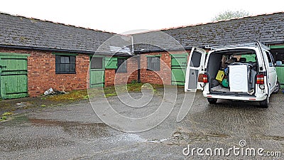 Clearing and removing furniture and appliances from an old English farmhouse Stock Photo
