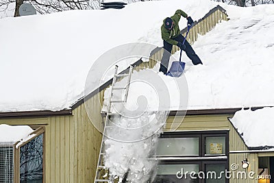 Clearing Snow from a Roof in Quebec Editorial Stock Photo
