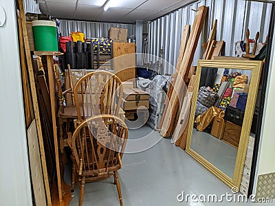 Clearing a storage unit full with household furniture Stock Photo