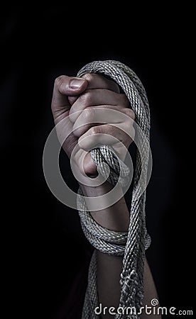 Clenched fist with tied up with a rope. Stock Photo