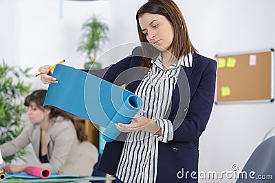 clerical worker unrolling blue scroll Stock Photo