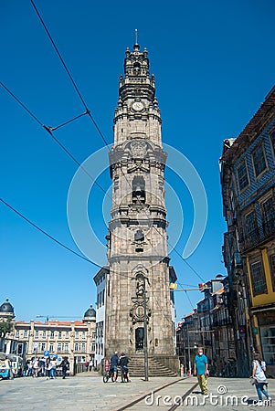 Clerigos Church in Porto, vertical shot from the foot of the tower and the overhead line in the blue sky - Vertical, Portugal, Editorial Stock Photo