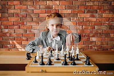 Clever schoolgirl, chess player at the table Stock Photo
