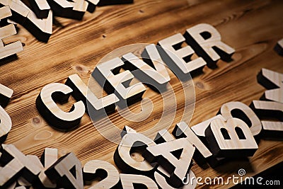 CLEVER word made with block letters lying on wooden board Stock Photo