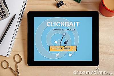 Clickbait concept on tablet screen with office objects Stock Photo