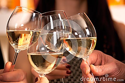 Clicking glasses with white wine. Stock Photo