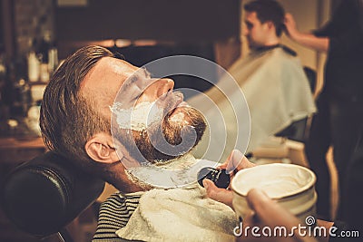 Client during beard shaving Stock Photo