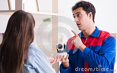 Client getting securty camera installed at home by contractor Stock Photo