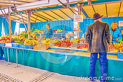 The client at the grocery stall in Salzburg Market, Austria Editorial Stock Photo