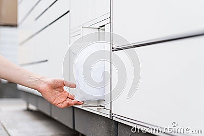 Client receive a parcel in self-service post terminal Stock Photo