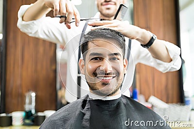 Client Smiling While Getting Hair Service From Hairdresser Stock Photo