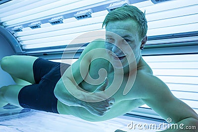 Client in a solarium on tanning bed Stock Photo