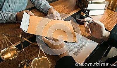 Client is submitting information on the paper of the prosecution document to the lawyer Stock Photo