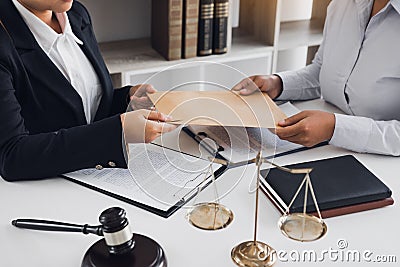 Client is submitting information on the paper of the prosecution document to the lawyer Stock Photo