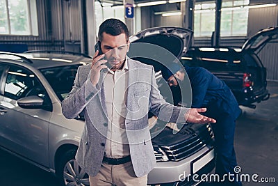 Client talking on the smartphone, he is displeased, complaining Stock Photo