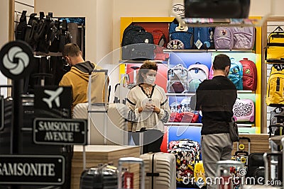 Clients and female staff of a suitcase and travel bags shop wearing a respiratory face mask in Belgrade Editorial Stock Photo