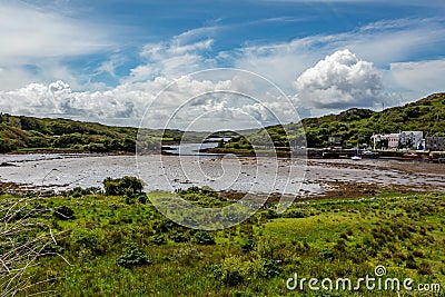 Clifden bay at low tide with boats anchored on the pier Stock Photo