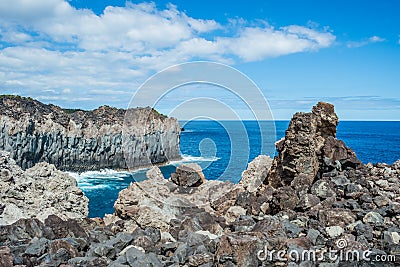 Stacked cliff volcanic rocks next to the turquoise sea in Alagoa da FajÃ£zinha, Terceira - Azores PORTUGAL Stock Photo