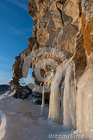 Cliff with a hole like a heart covered with ice splashes Stock Photo
