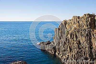 The cliff with the sea in Riomaggiore Stock Photo