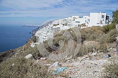 Cliff with Sea View, Whitewashed Houses and Trash, Santorini, Cyclades, Greece Stock Photo