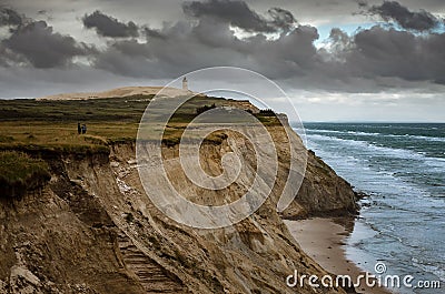 Cliffs in Lonstrup, Rubjerg Knude lighthouse on a dune in the background, north Jutland, Denmark Stock Photo