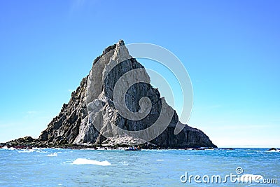 Cliffs of Point Wild, Elephant Island, Antarctica, with Zodiac in front Stock Photo