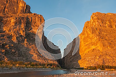 Cliffs rise steeply from Rio Grande River. Stock Photo