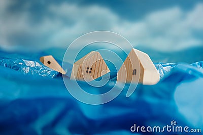 Climate Change Effect, Environment Issue. Conceptual Photo. Wooden Miniature House in Flood. Environmental Impact. Global Issues, Stock Photo