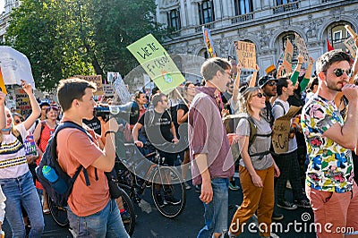 Climate Change protesters holding placards and bullhorns at an Extinction Rebellion protest march on Whitehall, London Editorial Stock Photo