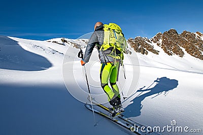 Climb with skis and seal skins in virgin snow Stock Photo