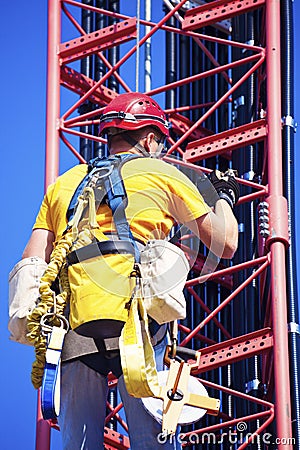 Climber ascending the cellular tower Stock Photo