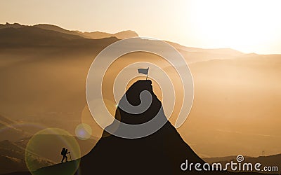 Climber Businessman Climbing A Mountain Peak in order to achieve His high goal. Self challenge, Business Goals achievement and Stock Photo