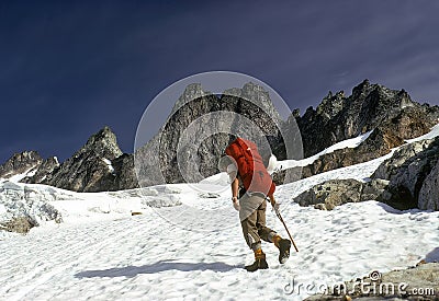 Climber crossing snowfield Stock Photo