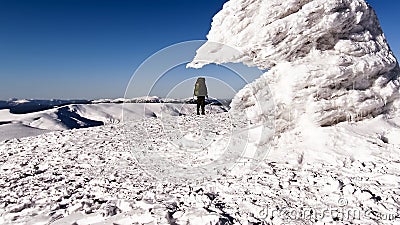 Climber on frozen mountain top Stock Photo