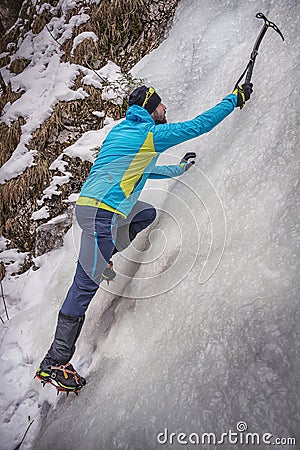 Climber on a frozen waterfall Stock Photo