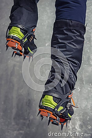 Climber on a frozen waterfall. Crampons close-up on his feet ice climber Stock Photo
