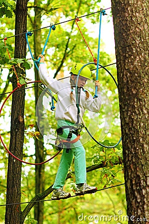 Climber girl engaged in training between trees Stock Photo