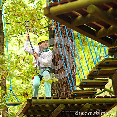 Climber girl engaged in training between trees Stock Photo