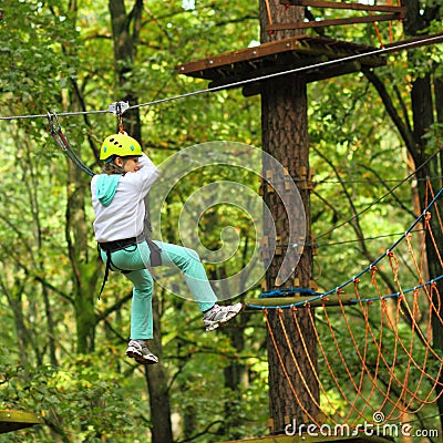 Climber girl engaged in training between trees Stock Photo