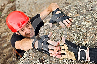 Climber Lending Helping Hand Stock Photo