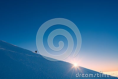 A climber looking to the sun Stock Photo
