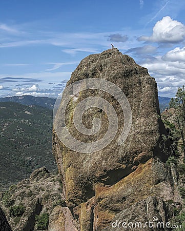Climber on top of massive rock Stock Photo
