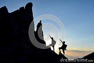 Climbers accessing pointy rocks Stock Photo